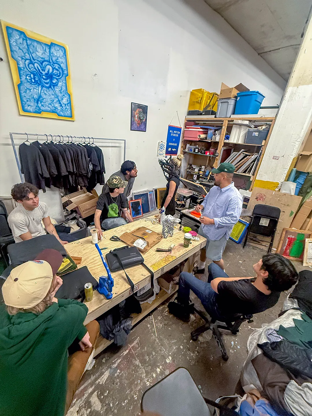 THE BACK ROOM team and All-Motion Studio gathered around a worktable in the studio.
