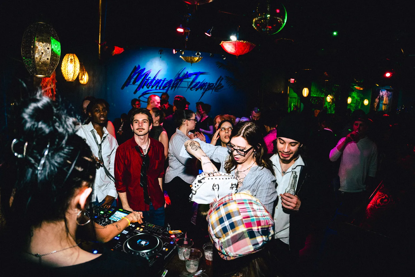 THE BACK ROOM Vol. 1 at Midnight Temple: a DJ plays to a packed room under lanterns and a disco ball.