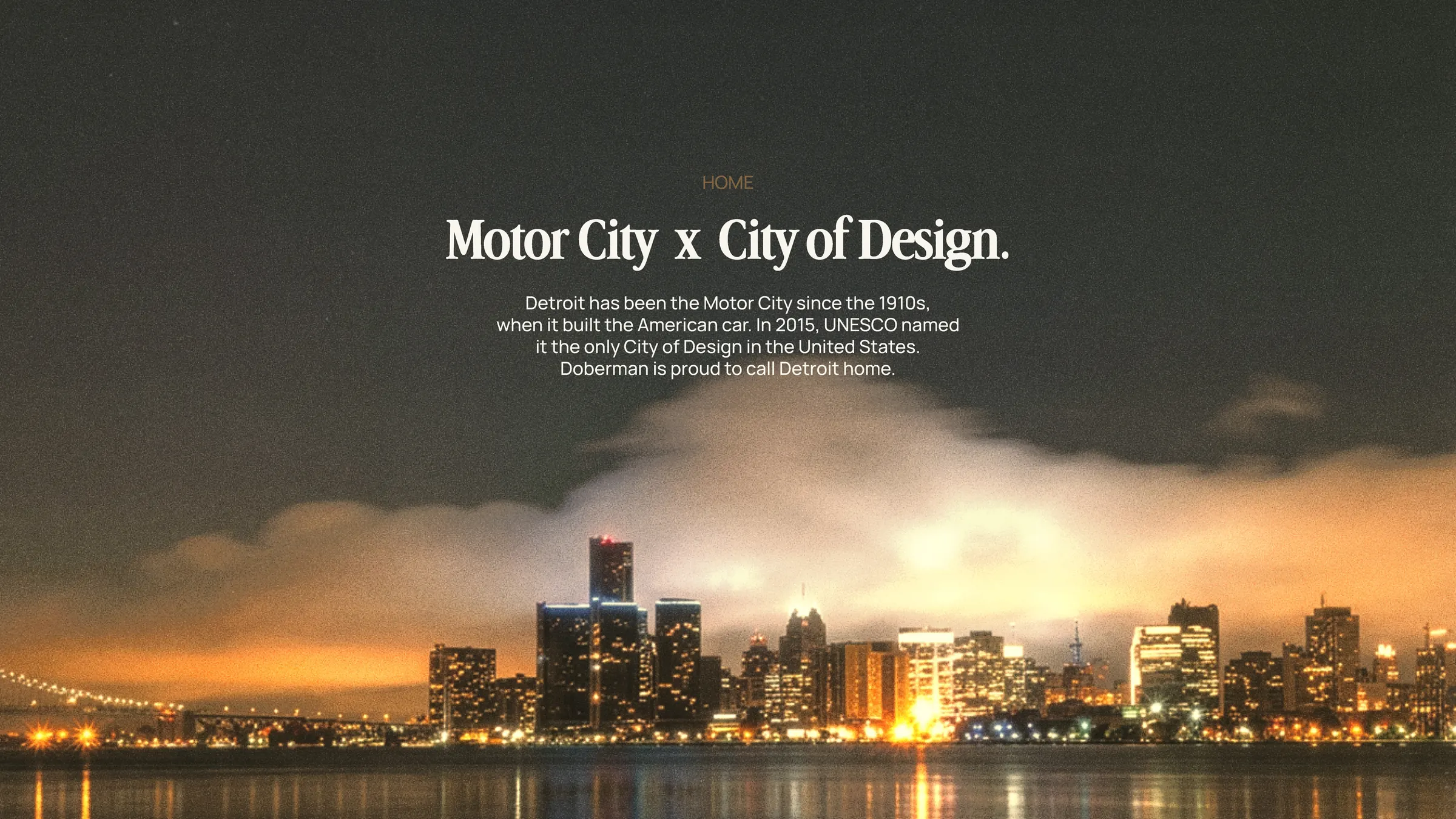 Deck slide: Motor City x City of Design, over the Detroit skyline at night.