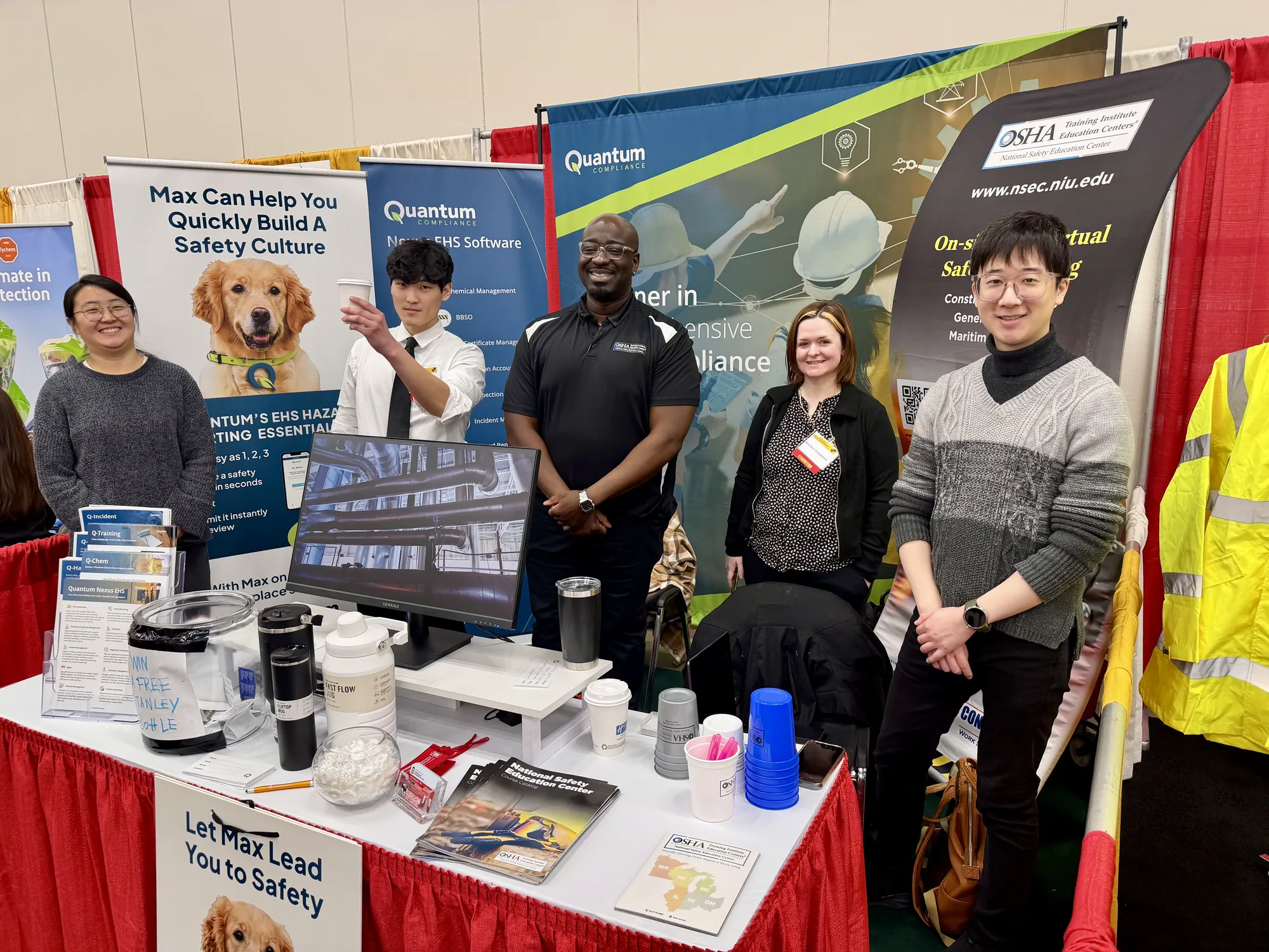 Young with the Quantum Compliance team at their trade show booth